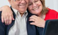 Happy senior couple smiling while making a video call at home, connected and joyful.