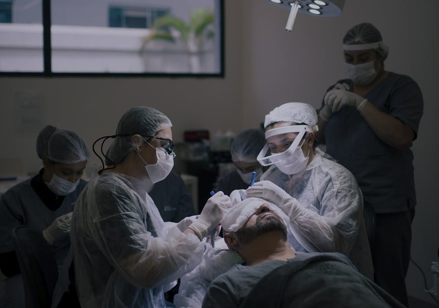 Surgeons conduct a hair transplant procedure in a modern operating room.